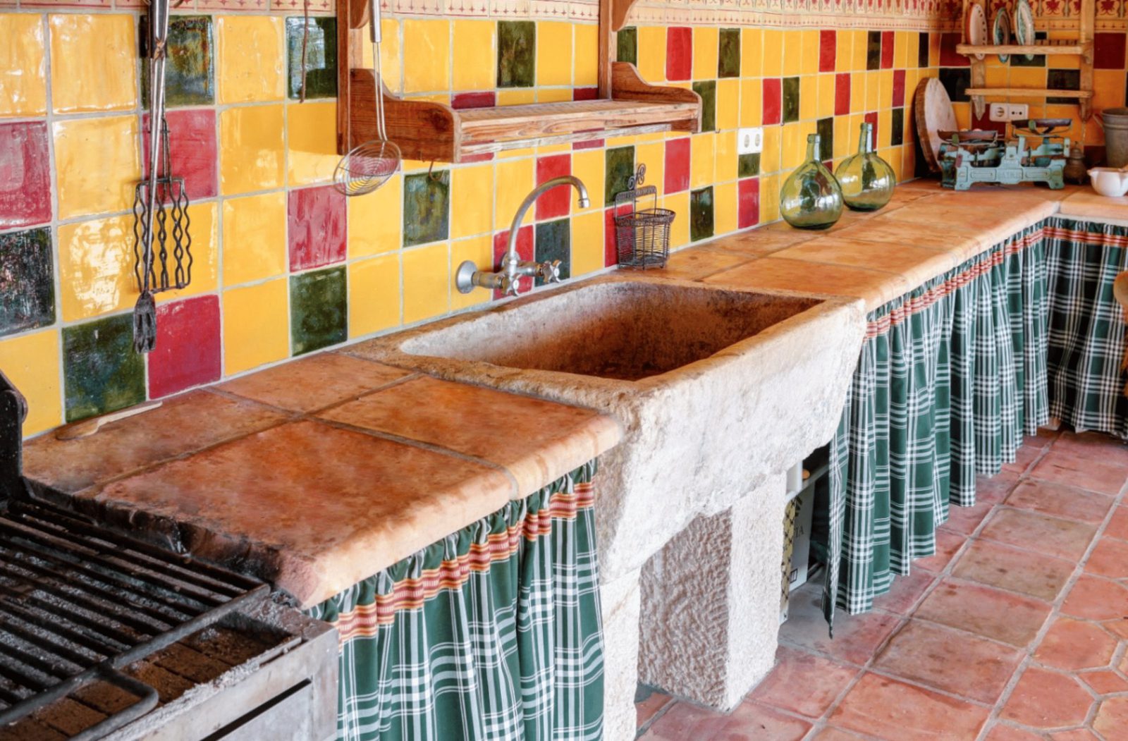 A charming kitchen with colorful tilework and a stone sink in a 4-bedroom finca in Moraira - The Estates