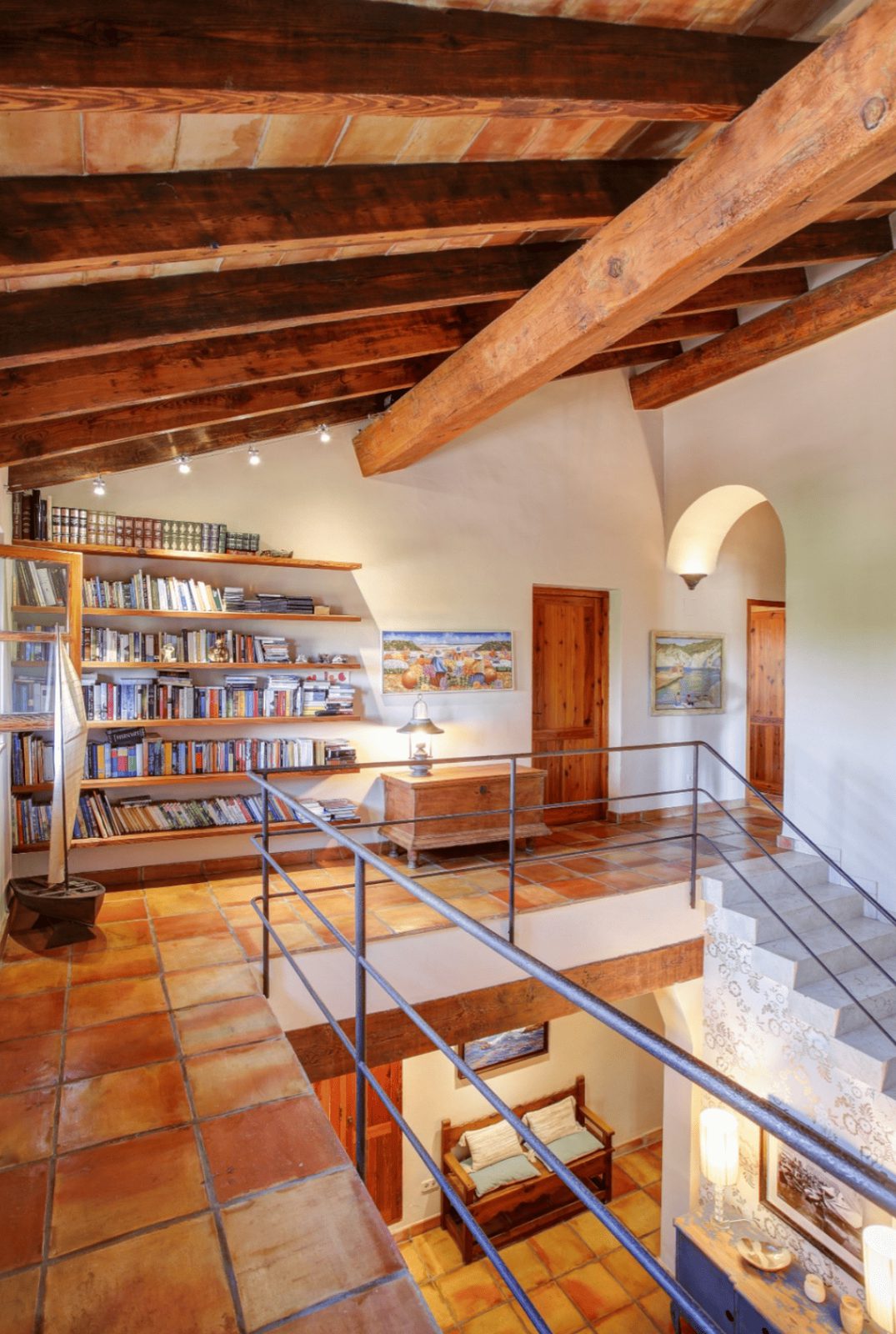 Interior view of a rustic living space with exposed beams and tiled floors in a 4-bedroom finca in Moraira - The Estates