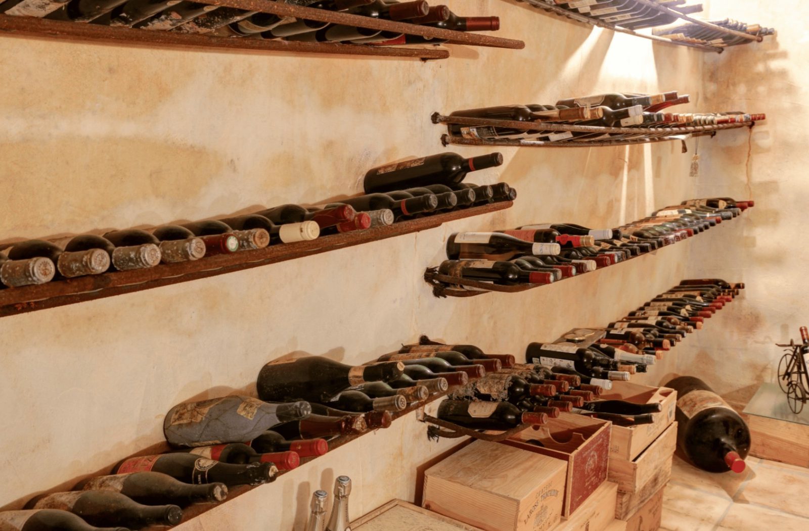 A well-stocked wine cellar with rows of bottles and wooden racks in a 4-bedroom finca in Moraira - The Estates