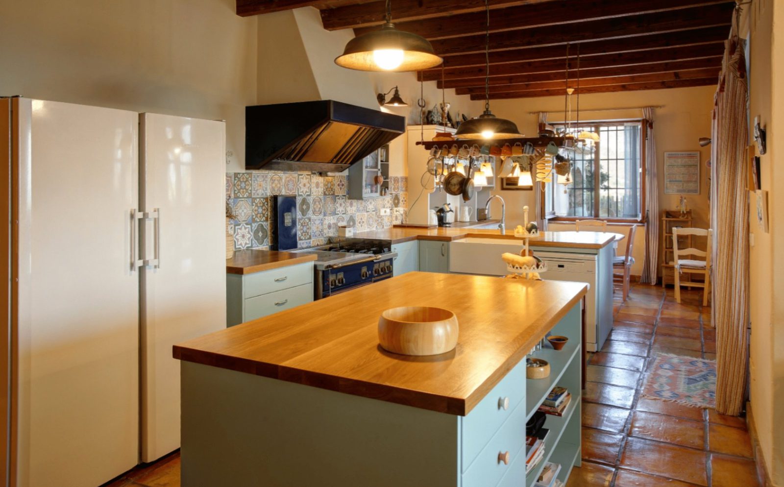 A bright, spacious kitchen with tiled floors and exposed beams in a 4-bedroom finca in Moraira - The Estates