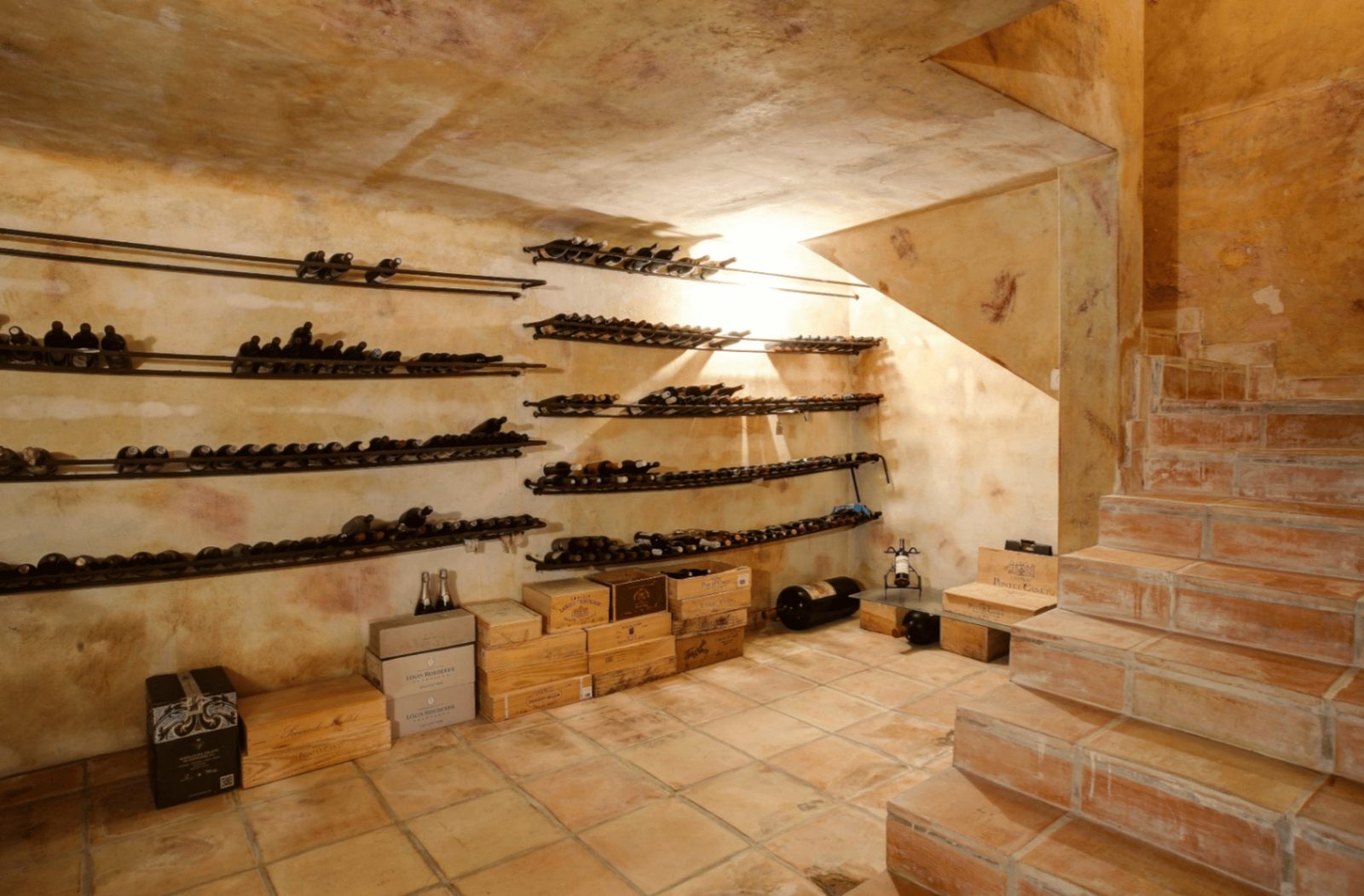 A well-stocked wine cellar with brickwork and tiled floors in a 4-bedroom finca in Moraira - The Estates