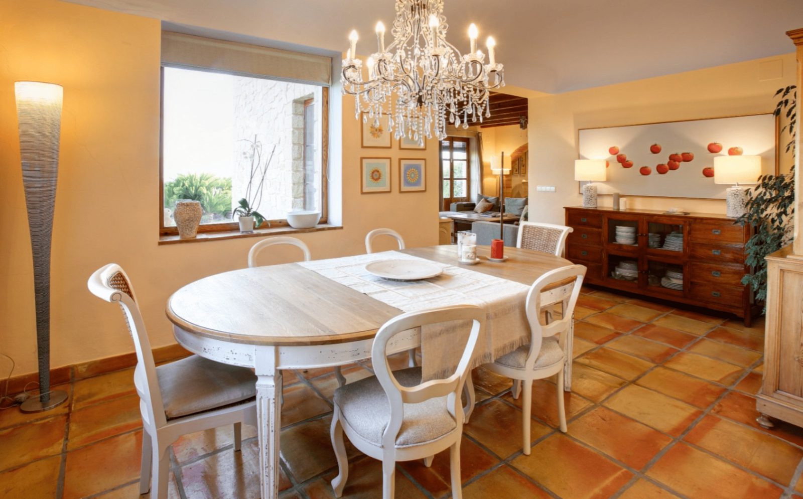 Elegant dining room with chandelier and tiled floor in a 4-bedroom finca in Moraira - The Estates