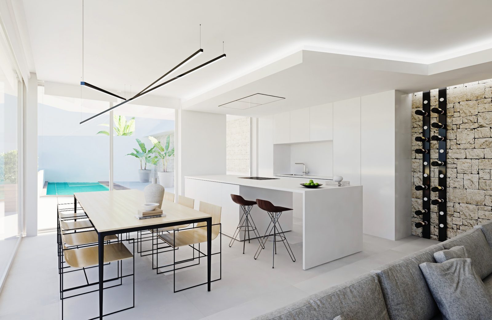 Open-plan kitchen and dining area with pool views in a