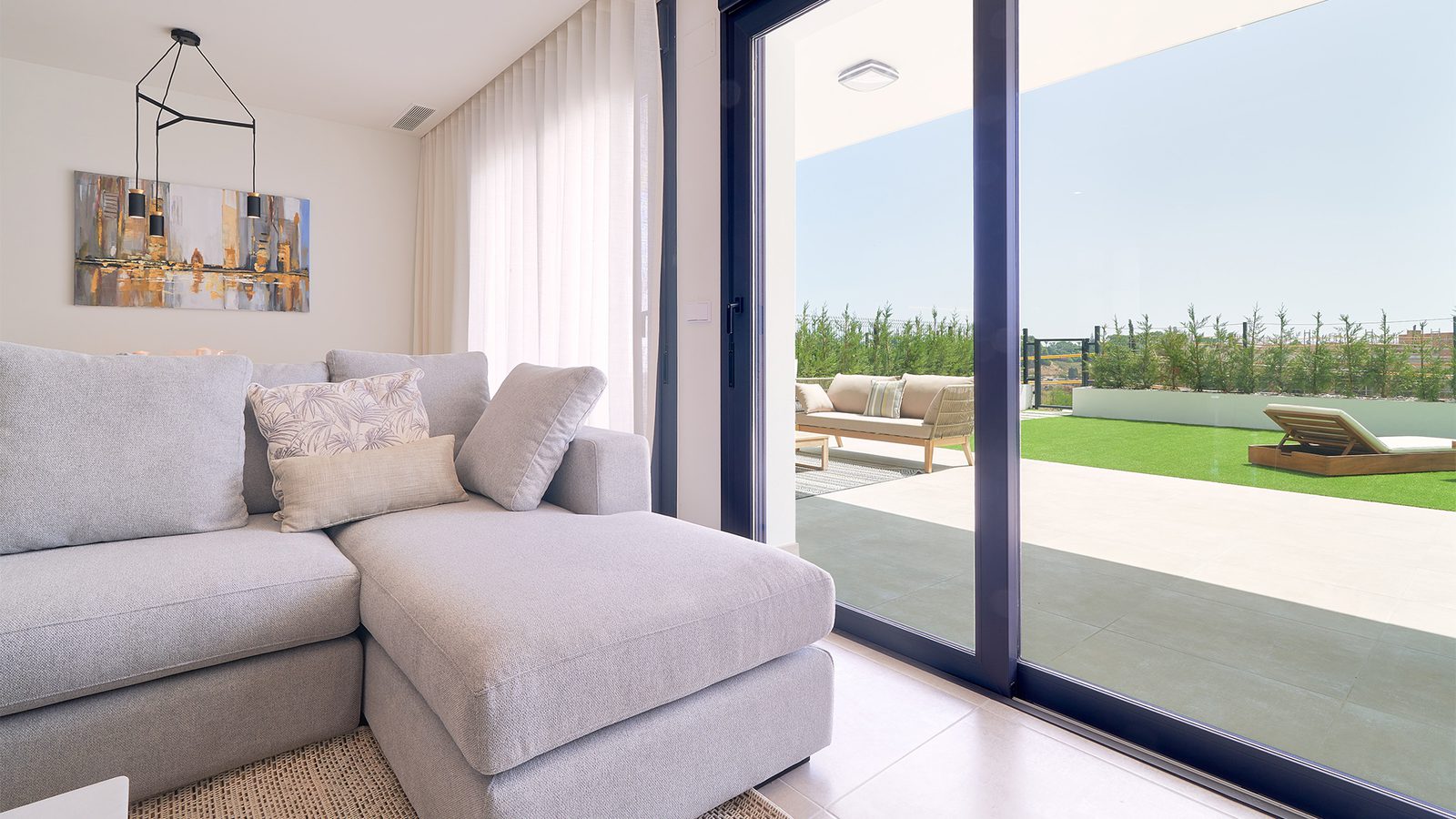 A bright living area with patio access in a 3-bedroom apartment in Estepona - The Estates
