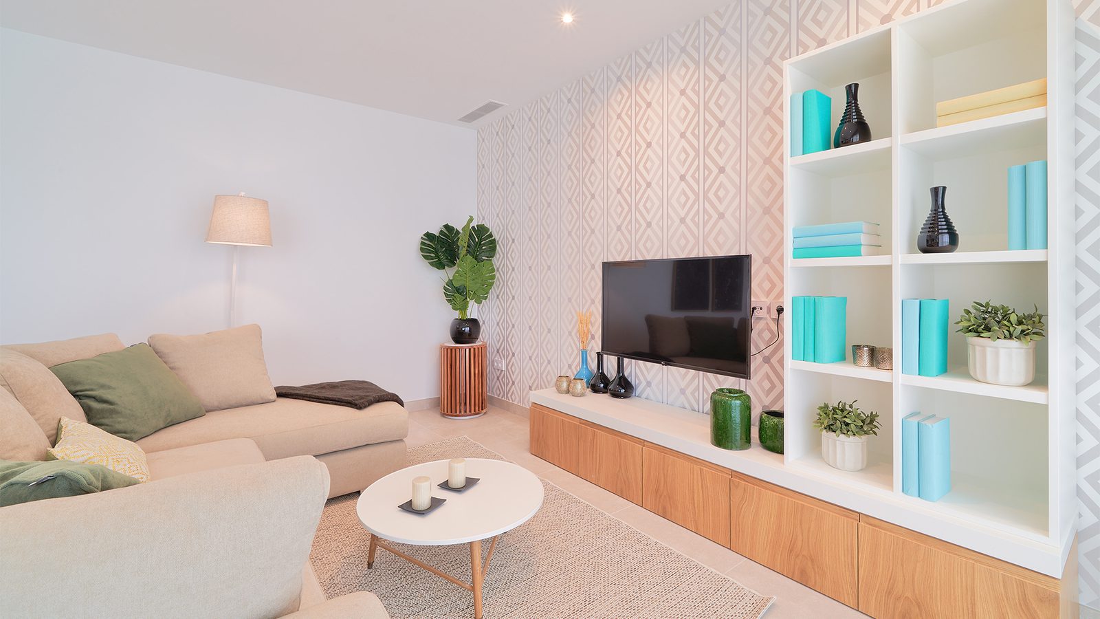 Stylish living room with a TV and shelving in a 3-bedroom apartment in Estepona - The Estates