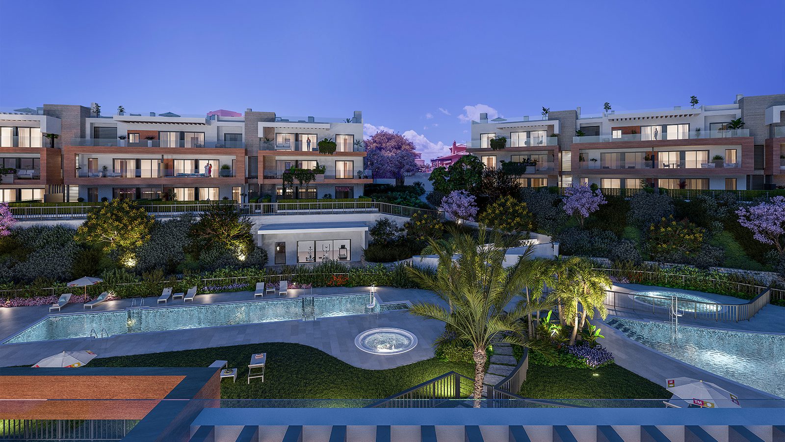 Exterior view of a 3-bedroom apartment complex with a pool and gardens in Estepona - The Estates