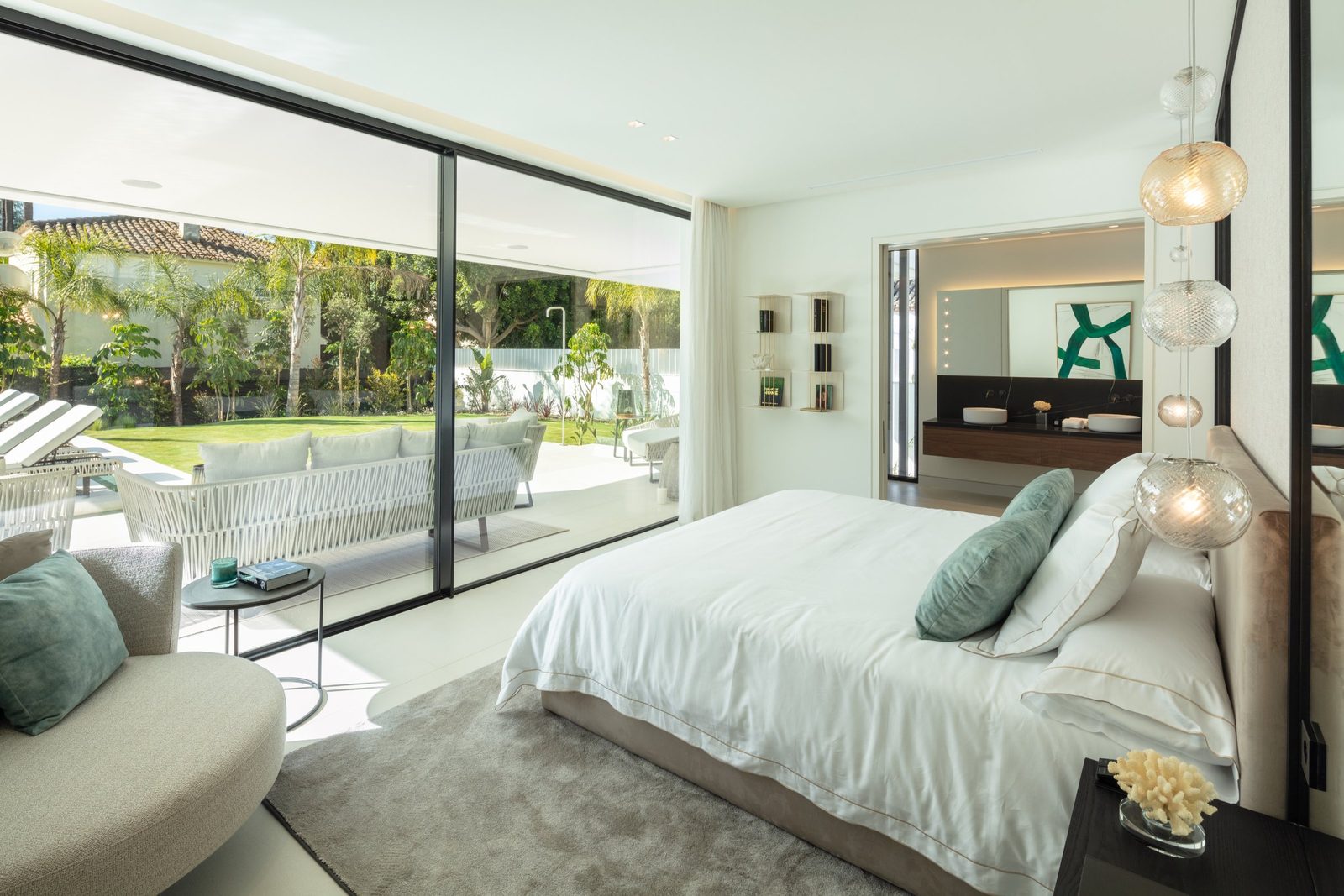 Contemporary bedroom with garden views and ensuite bathroom of a 5-bedroom villa