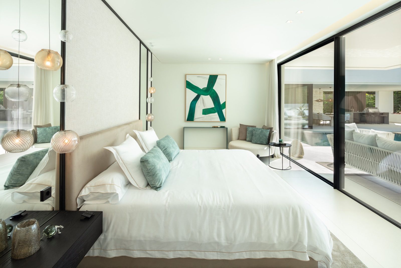 Bright modern bedroom with king bed, pendant lights