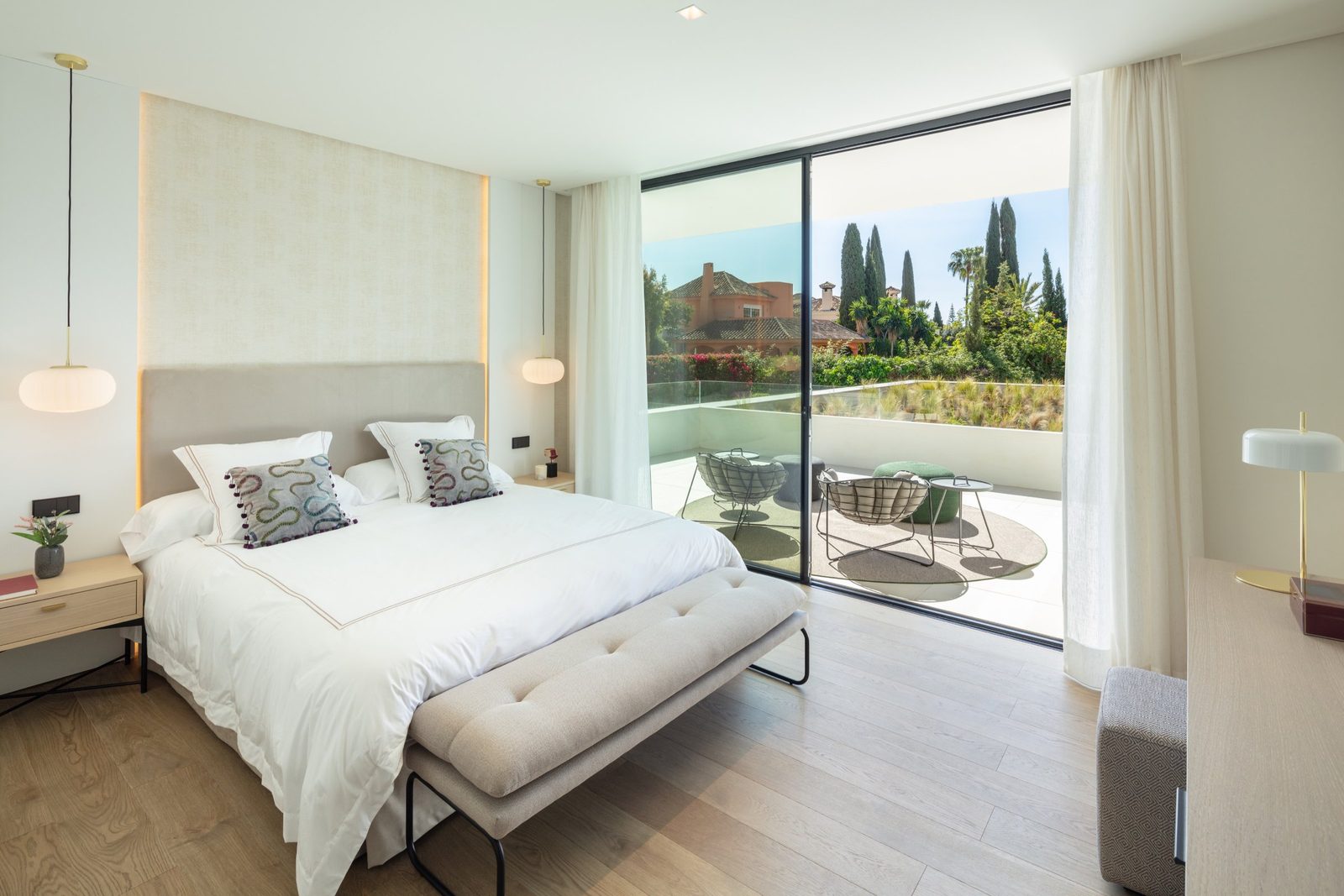 Bright bedroom with terrace seating and garden views in a 5-bedroom villa in Málaga - The Estates