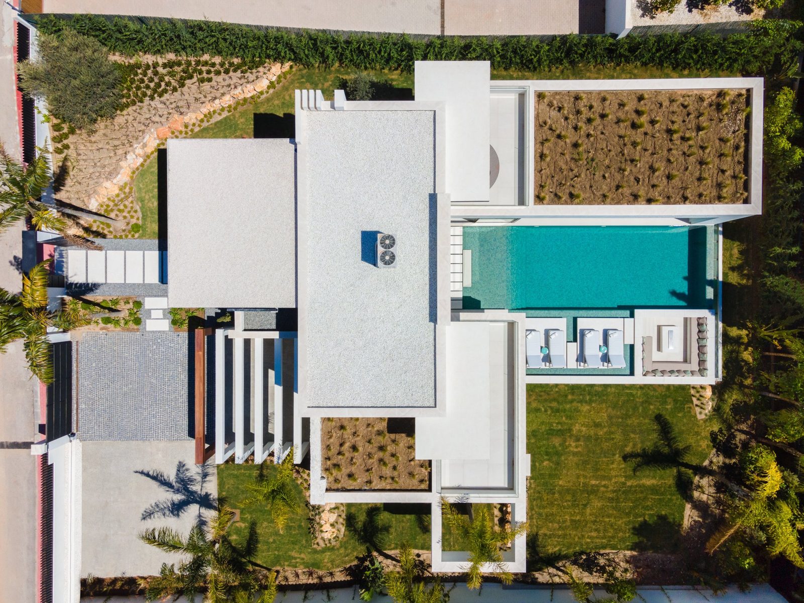 Aerial view of a modern villa with pool and landscaped gardens, a 5-bedroom villa in Málaga - The Estates