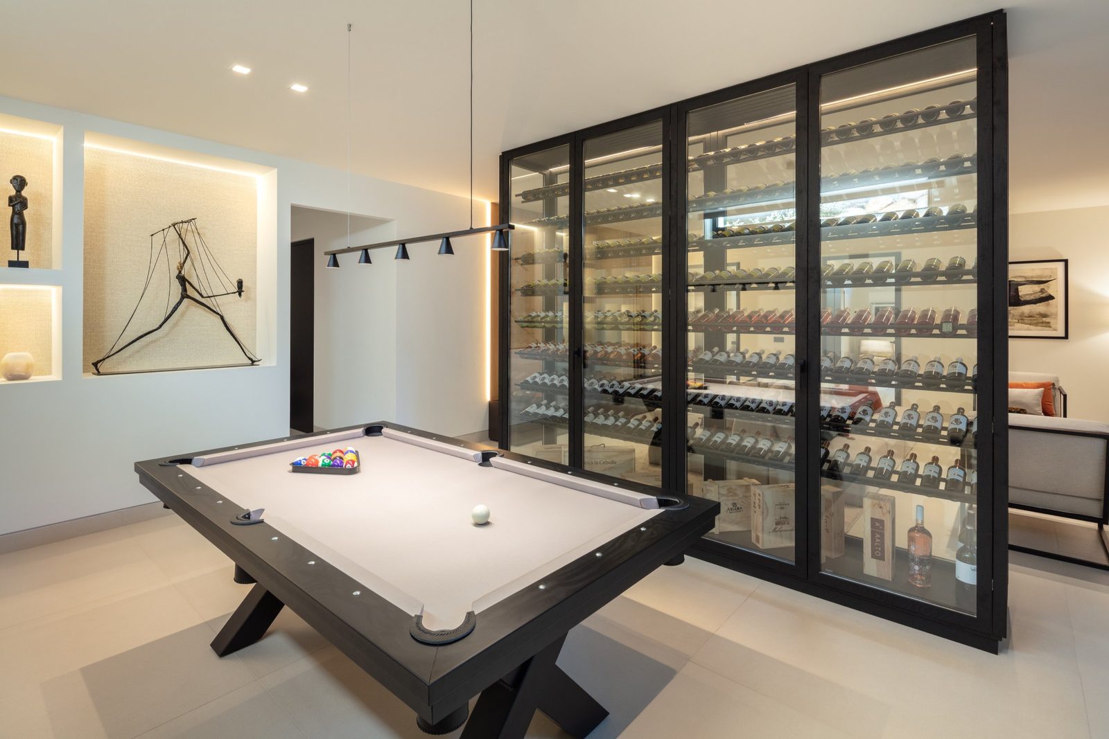 Billiards room with a pool table and glass-enclosed wine cellar in a 5-bedroom villa in Málaga - The Estates