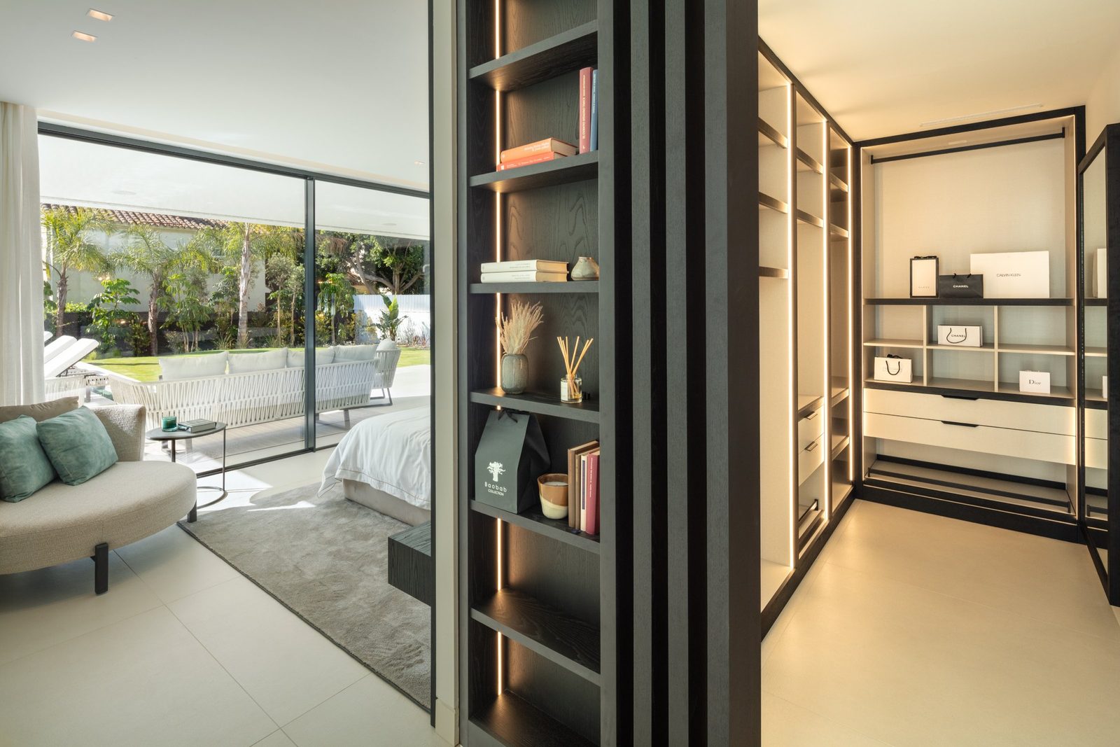 Bedroom with garden views and illuminated walk-in wardrobe of a 5-bedroom villa in Málaga - The Estates