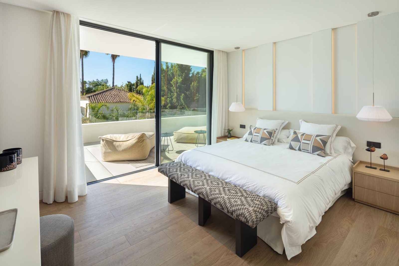 Contemporary bedroom with balcony and garden views in a 5-bedroom villa in Málaga - The Estates
