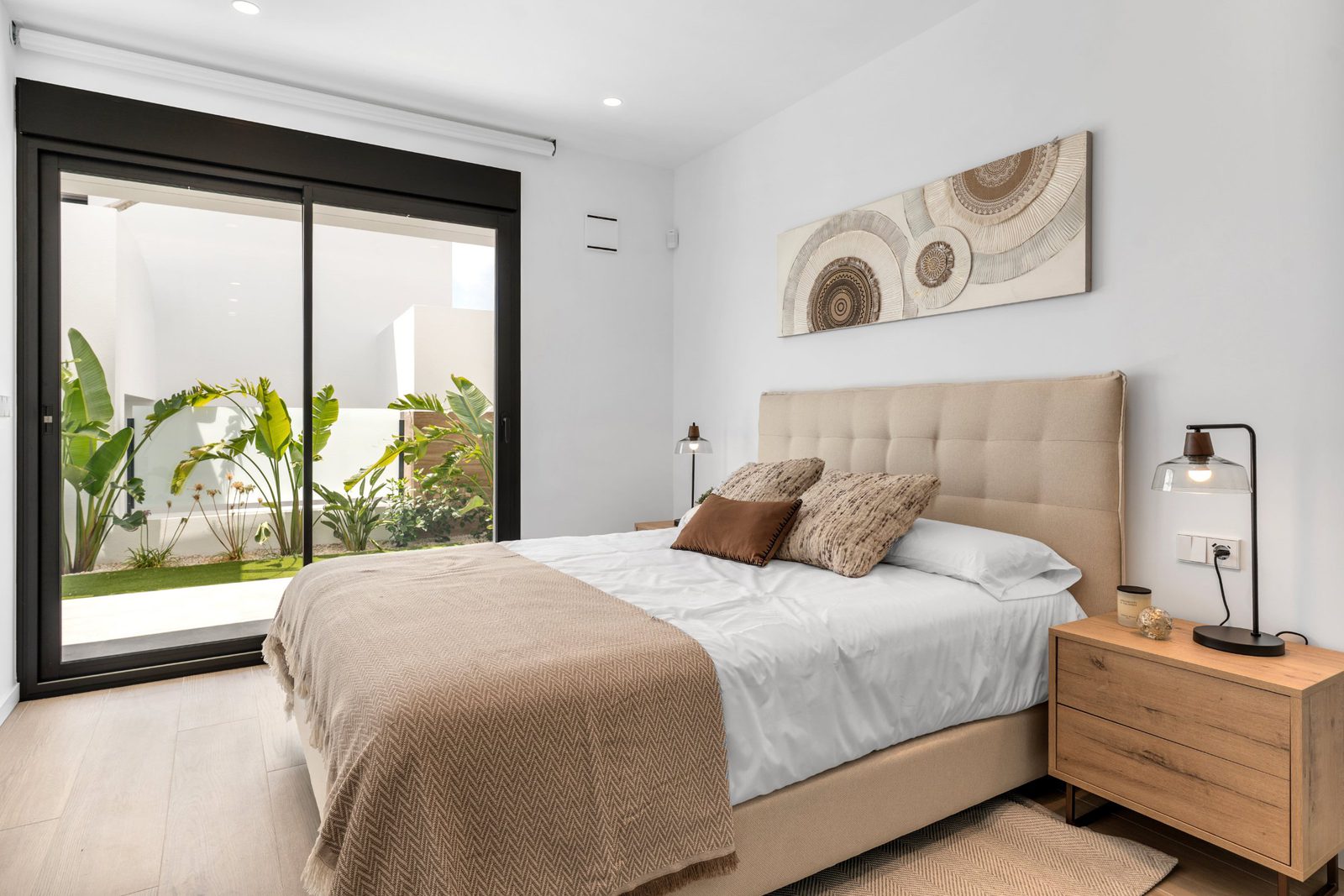 A bright bedroom with patio access in a 3-bedroom apartment in Benitachell - The Estates