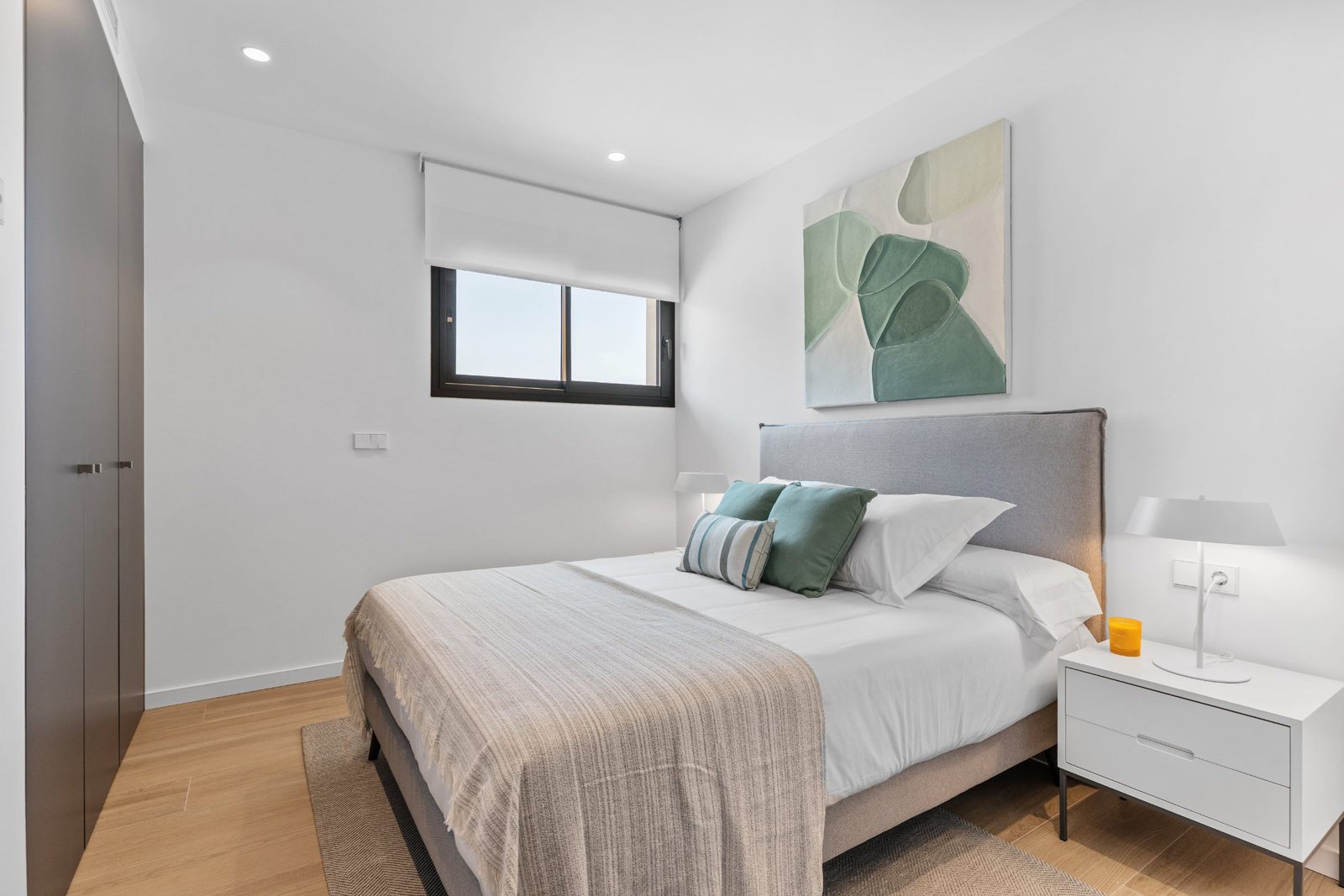 A bright bedroom with a double bed and window in a 3-bedroom apartment in Benitachell - The Estates