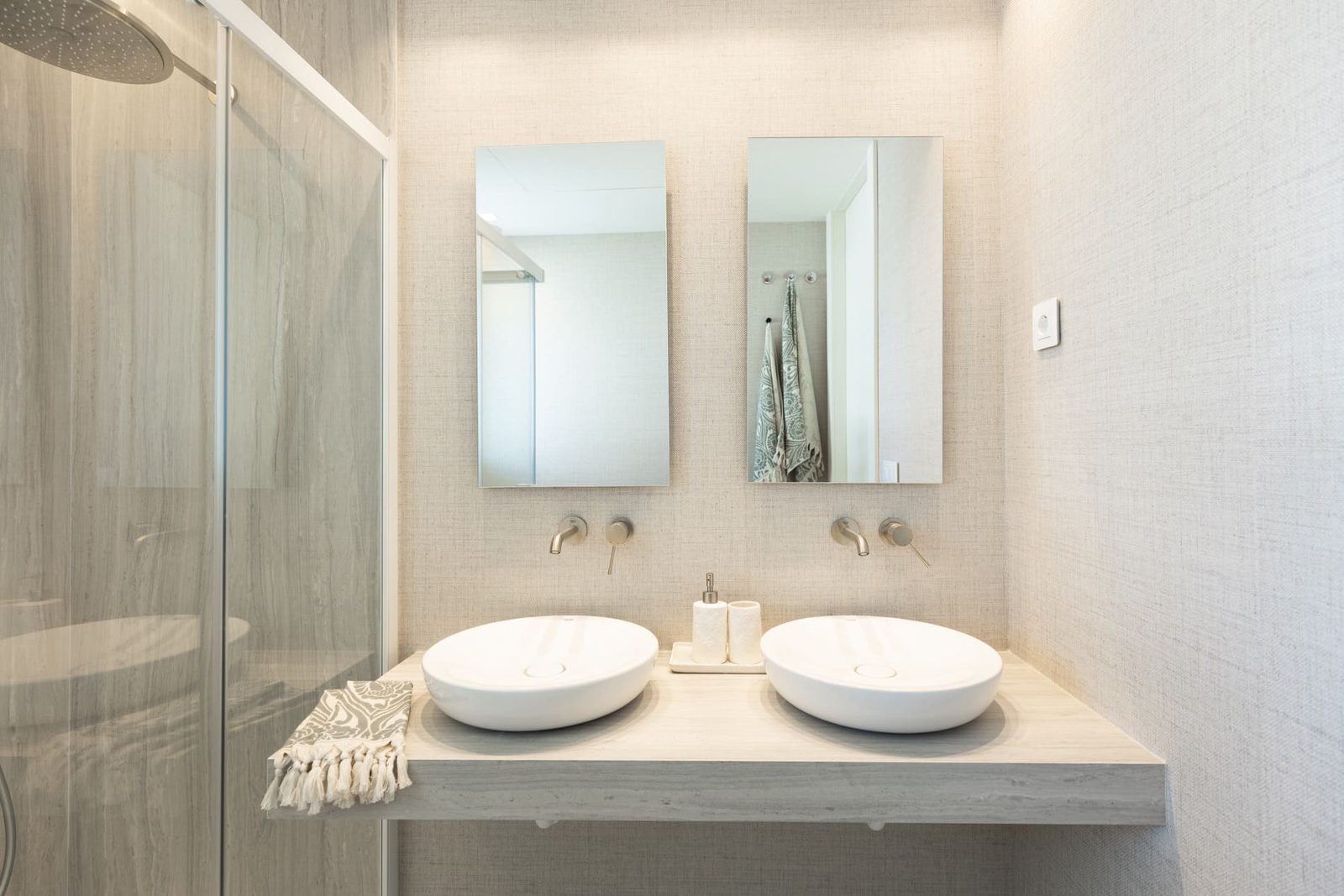 Modern bathroom with double vanity and walk-in shower in a 2-bedroom apartment in Benidorm - The Estates